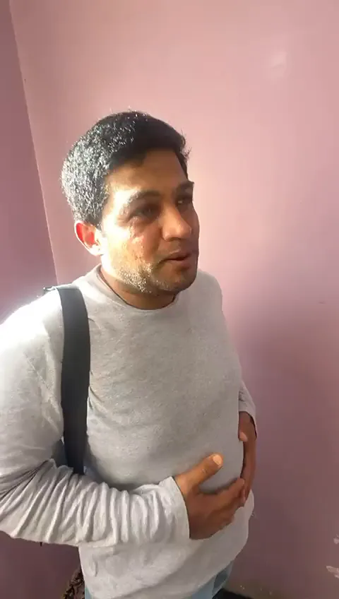 Our UAE guest at the Kashmiri wedding venue, backpack on his shoulder, patting his stomach as he talks to the camera