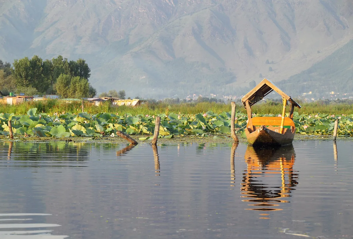 Empty wooden shikara floating on Dal Lake in Srinagar, Jammu and Kashmir