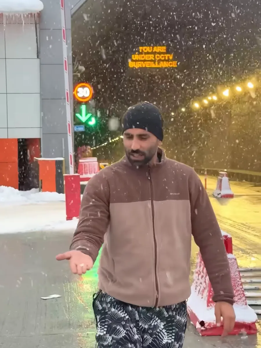 Our team at the Sonamarg Tunnel gate as the season's first snow falls, 13 October 2026